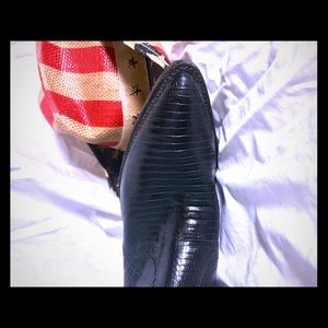 Dress boot.  Black snake skin, semi rounded toe.